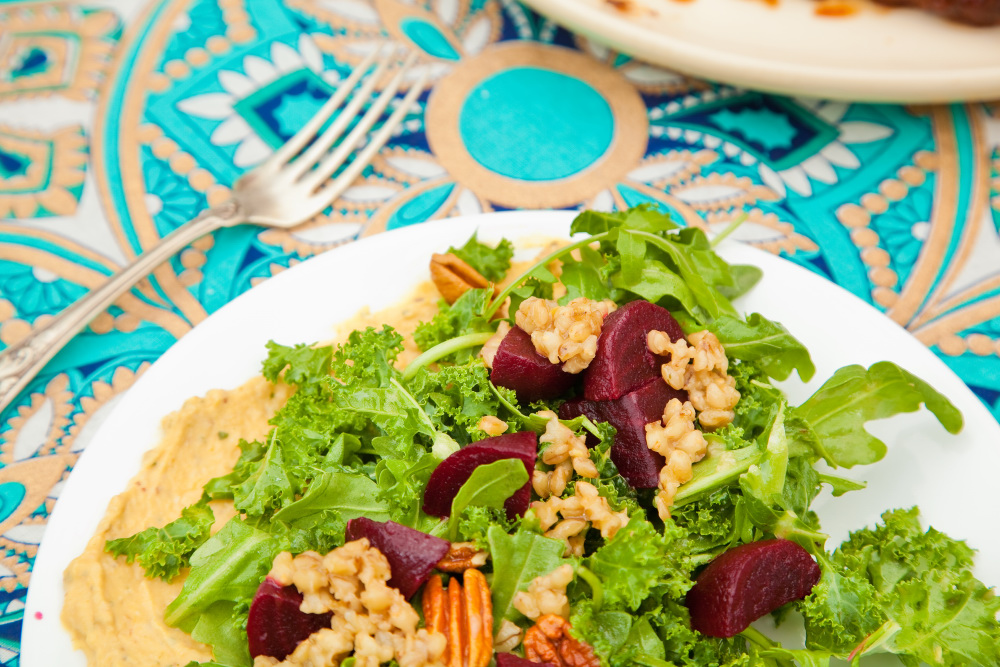 Salad with lettuce barley beetroot pecans and hummus