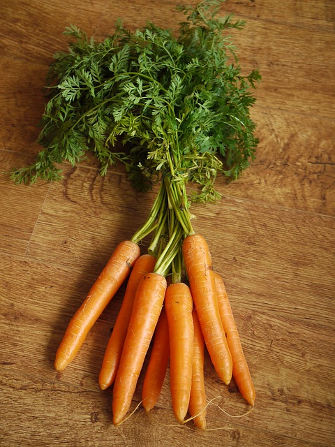 Eating Carrot Tops with Recipe Ideas - Carrots with Leafy Tops on Kitchen Bench